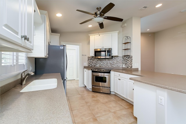 kitchen featuring white cabinets, light tile patterned floors, stainless steel appliances, and sink