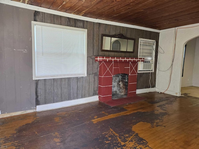 unfurnished living room with wood walls, dark hardwood / wood-style flooring, wood ceiling, and cooling unit