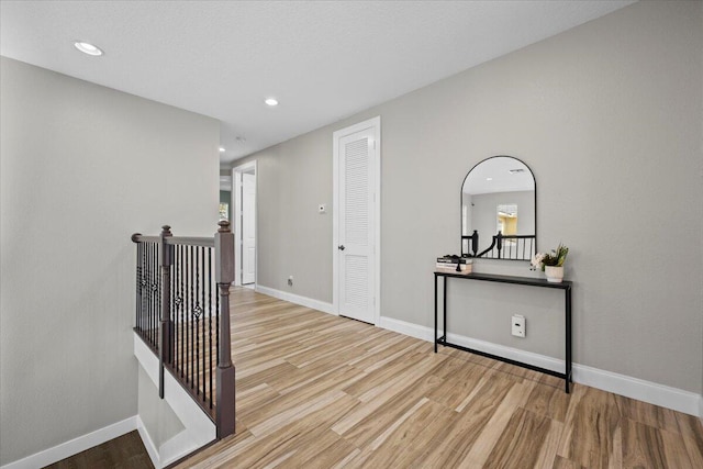 hall with light hardwood / wood-style flooring