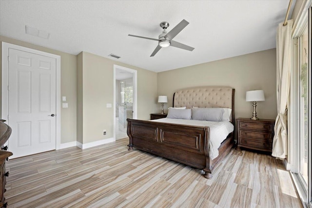 bedroom featuring ensuite bath, ceiling fan, and light hardwood / wood-style flooring