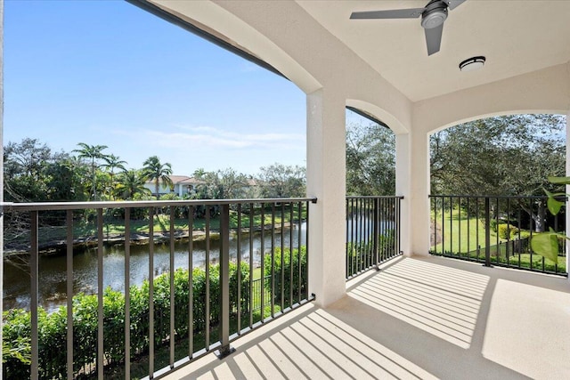 balcony with a water view and ceiling fan