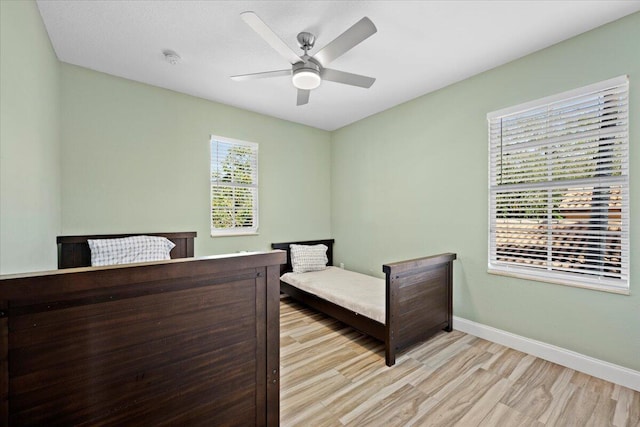 bedroom featuring light hardwood / wood-style floors and ceiling fan