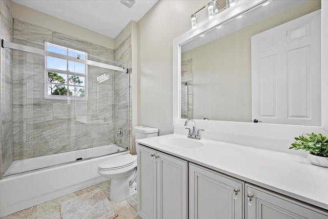 full bathroom featuring vanity, toilet, and combined bath / shower with glass door