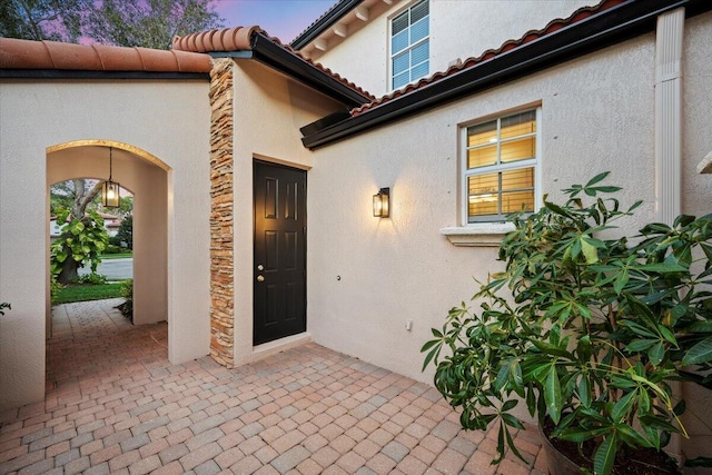 exterior entry at dusk with a patio