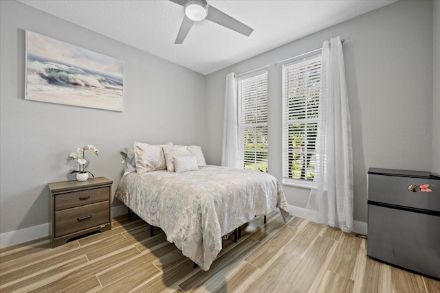 bedroom with ceiling fan and multiple windows