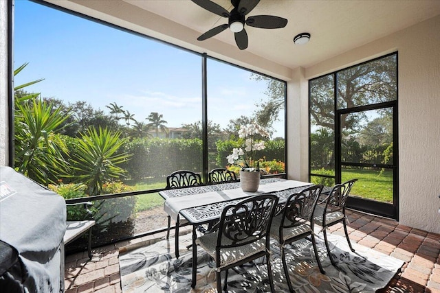 sunroom featuring ceiling fan