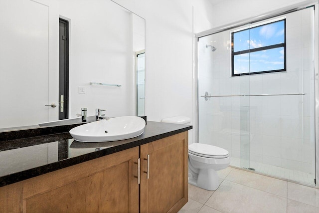 bathroom featuring tile patterned flooring, vanity, an enclosed shower, and toilet