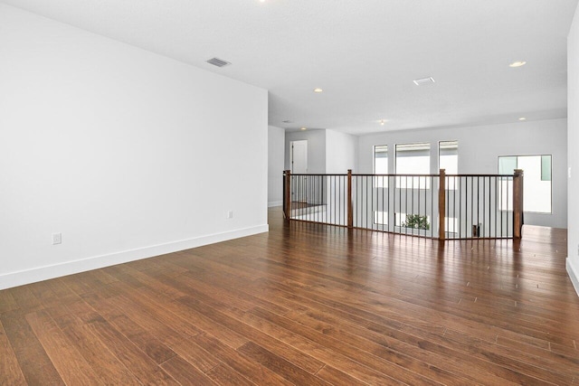 spare room featuring dark hardwood / wood-style flooring