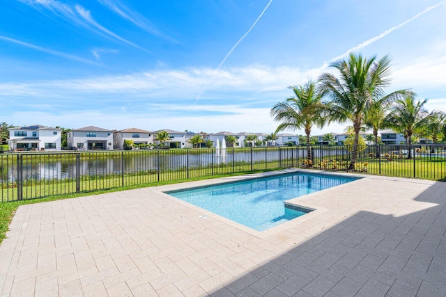 view of pool featuring a water view and a patio