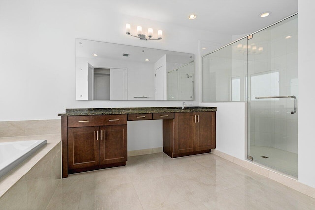 bathroom with tile patterned flooring, vanity, and independent shower and bath