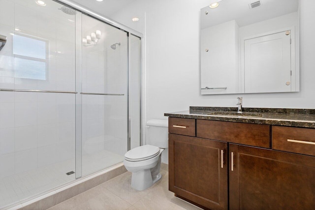 bathroom with toilet, tile patterned flooring, vanity, and walk in shower