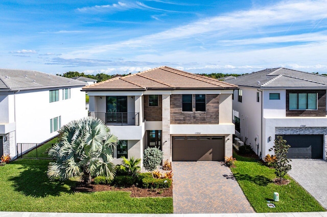 view of front of home with a balcony and a garage