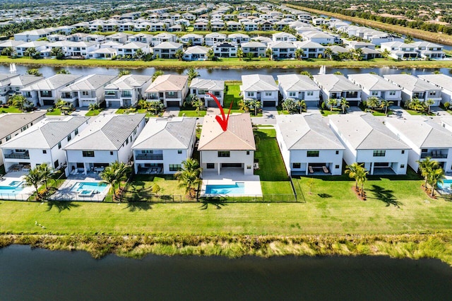 birds eye view of property with a water view