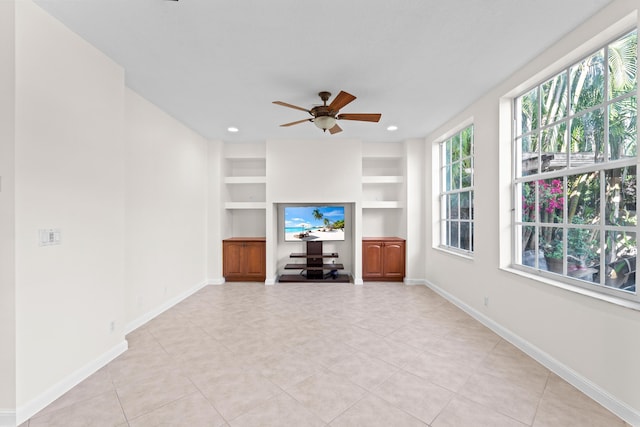 unfurnished living room with ceiling fan, built in features, and light tile patterned floors