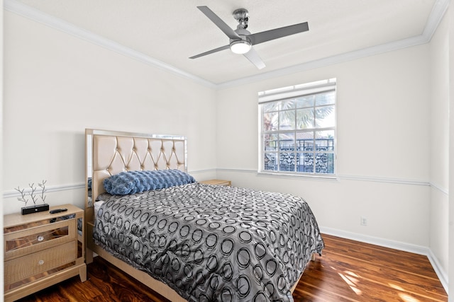 bedroom featuring crown molding, dark wood-type flooring, and ceiling fan