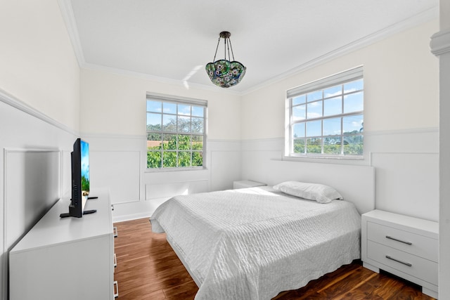 bedroom with multiple windows, ornamental molding, and dark hardwood / wood-style floors