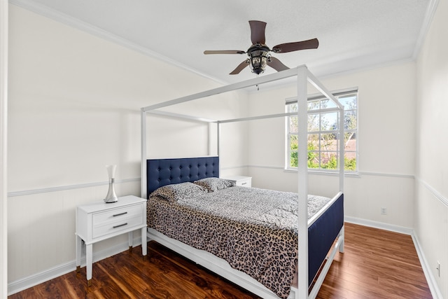 bedroom with crown molding, dark hardwood / wood-style floors, and ceiling fan