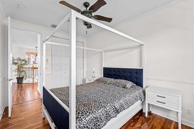 bedroom with wood-type flooring, ceiling fan, and crown molding