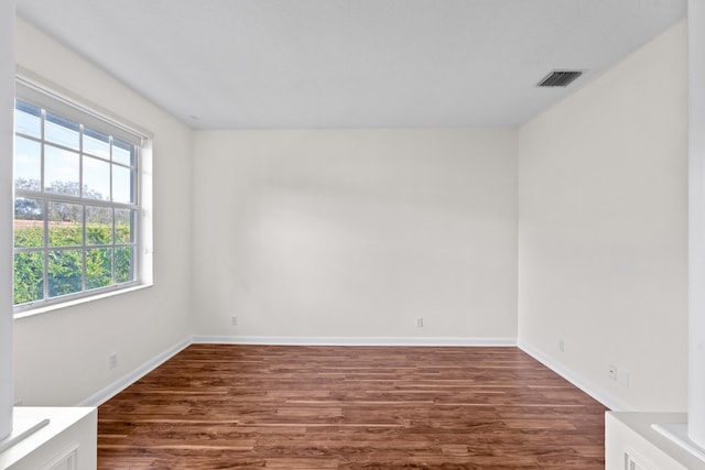 spare room with dark wood-type flooring