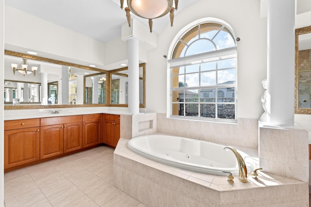 bathroom with tile patterned flooring, vanity, a relaxing tiled tub, and an inviting chandelier