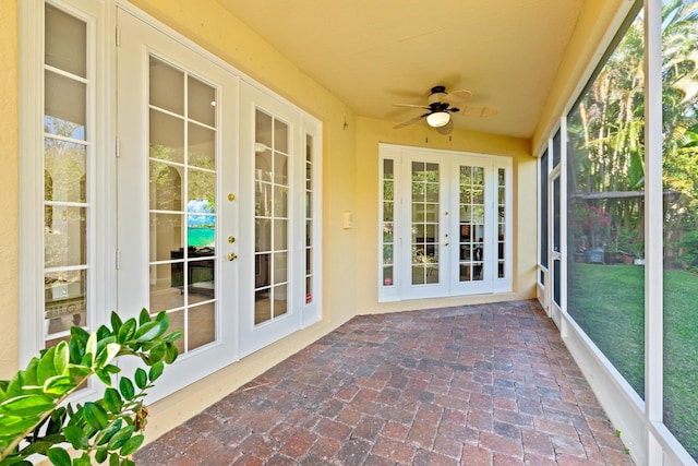 unfurnished sunroom with ceiling fan and french doors