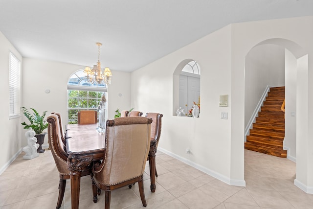 tiled dining space featuring a notable chandelier