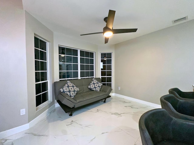 sitting room featuring ceiling fan