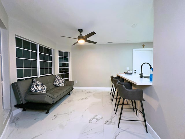 interior space with ceiling fan and sink