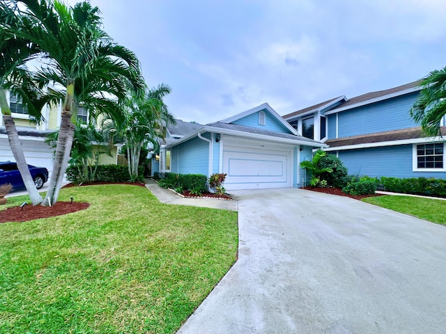 view of front of property featuring a front yard and a garage