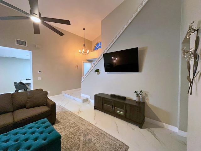 living room with lofted ceiling and ceiling fan with notable chandelier