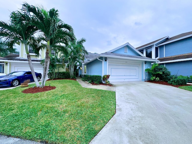 view of front of property featuring a front lawn and a garage