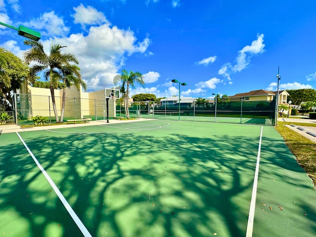 view of tennis court featuring basketball hoop