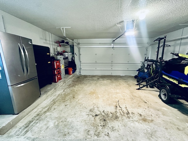 garage with stainless steel refrigerator