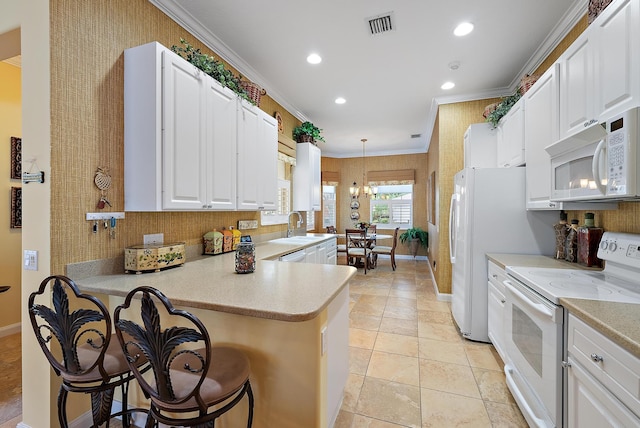 kitchen with white cabinetry, kitchen peninsula, decorative light fixtures, a kitchen breakfast bar, and white appliances