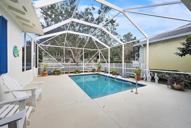 view of pool with glass enclosure and a patio