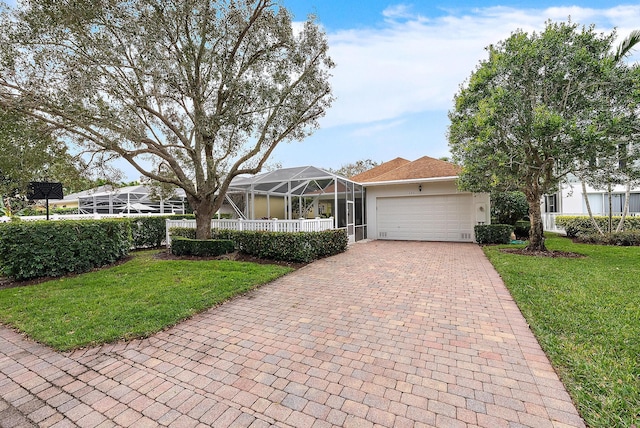 single story home featuring a front lawn and a garage