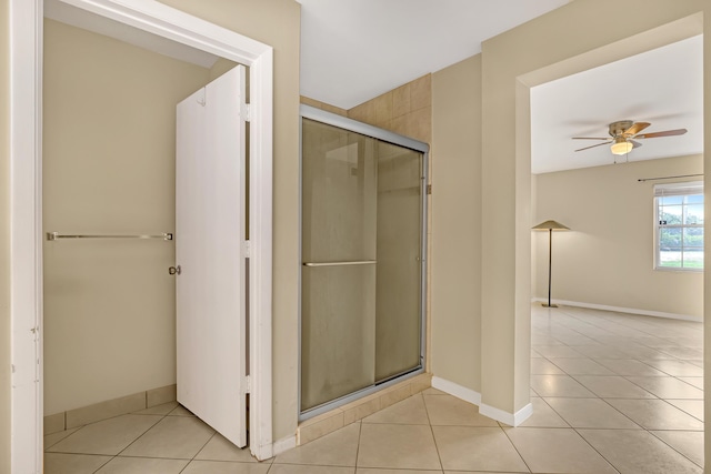 bathroom with tile patterned flooring, ceiling fan, and walk in shower