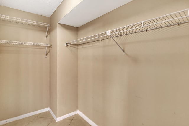 walk in closet featuring tile patterned flooring