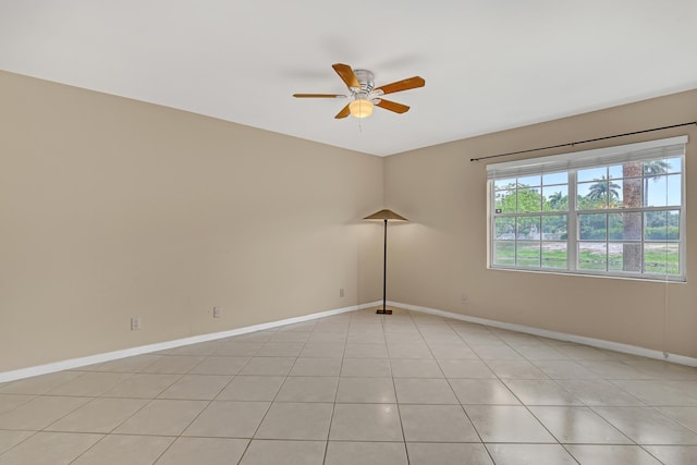 tiled empty room featuring ceiling fan