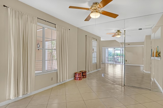 spare room featuring light tile patterned floors and ceiling fan