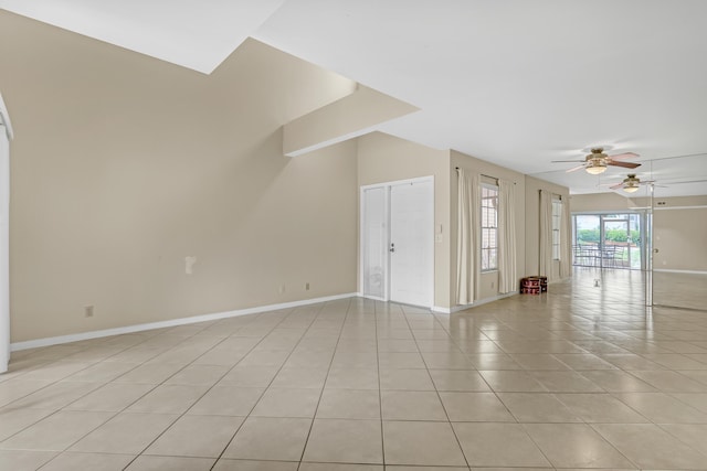 empty room with light tile patterned floors and ceiling fan