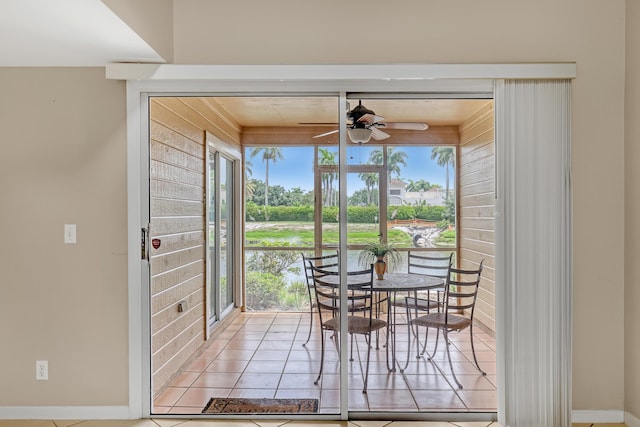 dining room with a wealth of natural light, light tile patterned floors, and ceiling fan