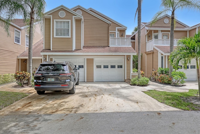 view of front of property featuring a balcony and a garage