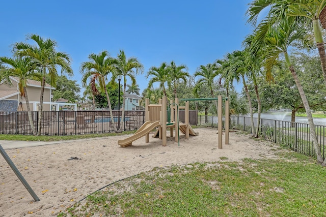 view of playground with a water view