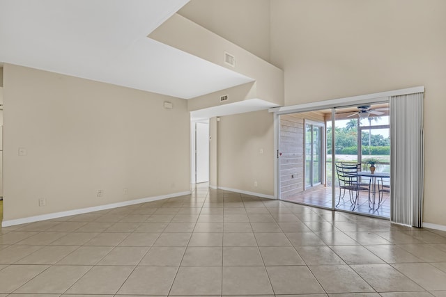 unfurnished room with ceiling fan and light tile patterned flooring