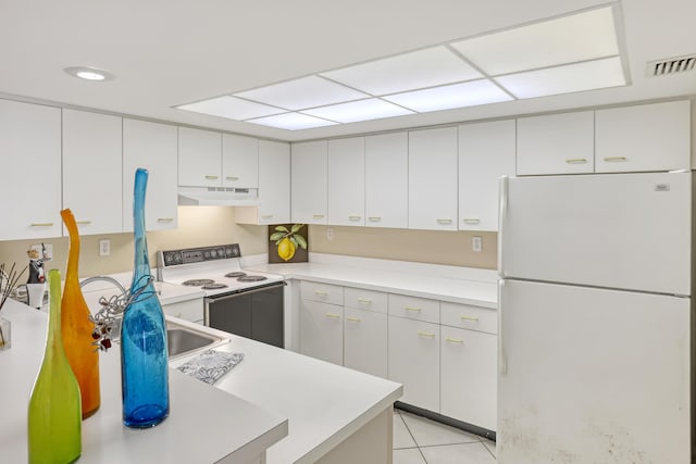 kitchen featuring white cabinetry, white appliances, and light tile patterned floors