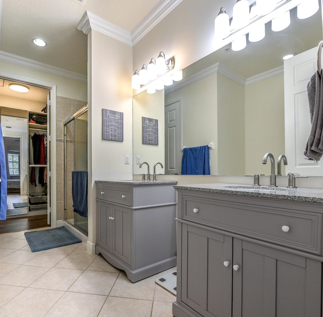 bathroom featuring tile patterned flooring, a shower with shower door, and ornamental molding