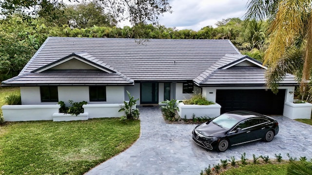 ranch-style home with a front yard and a garage