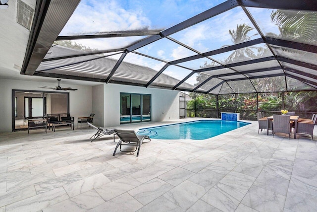 view of pool featuring pool water feature, a lanai, ceiling fan, and a patio