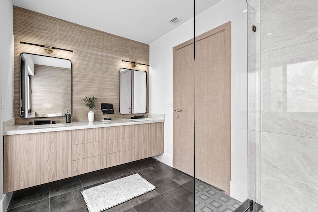 bathroom with a walk in shower, double vanity, visible vents, and tile patterned floors